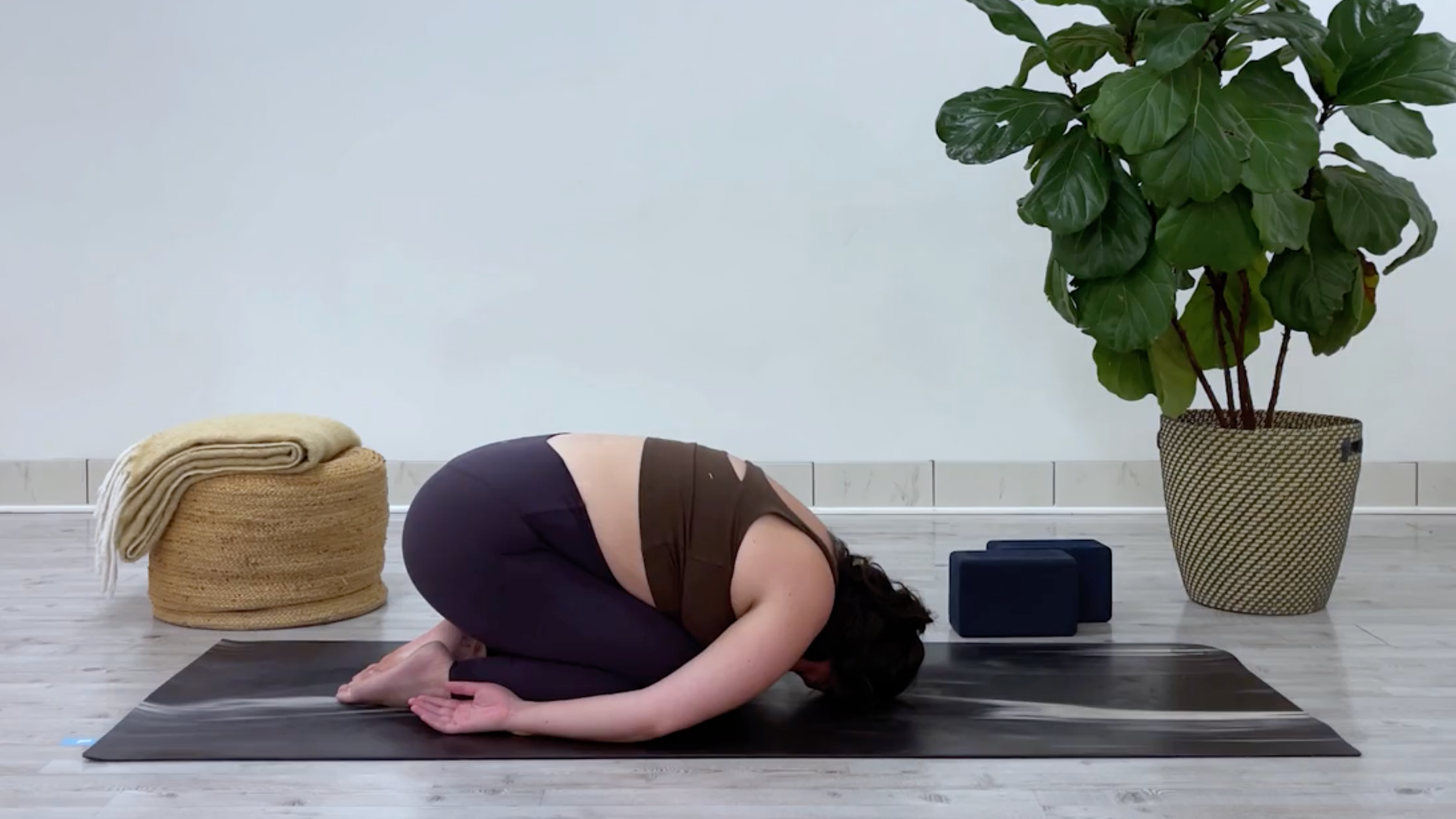 Yoga teacher Taylor Lorenz in Rock Pose, part of her yin yoga for stress routine